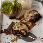 Brown mushrooms topped with mince and cheese sauce