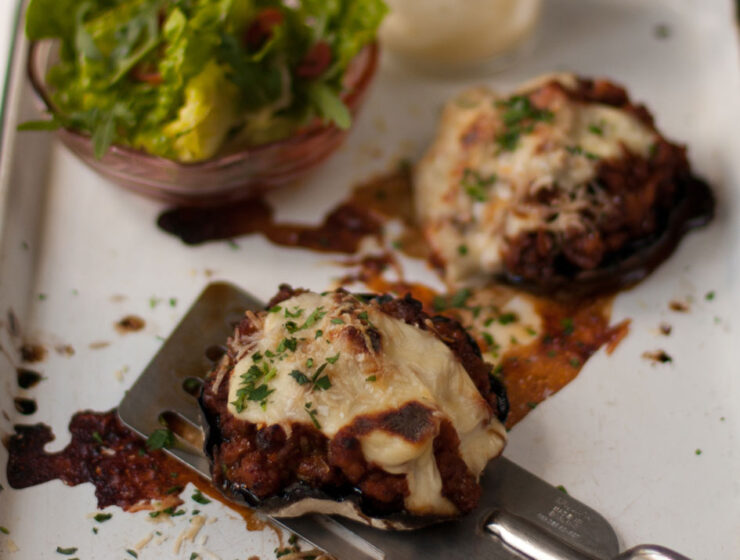 Brown mushrooms topped with mince and cheese sauce