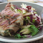 Succulent Pork Chops Wrapped in Bacon with Apple and Cranberry Slaw