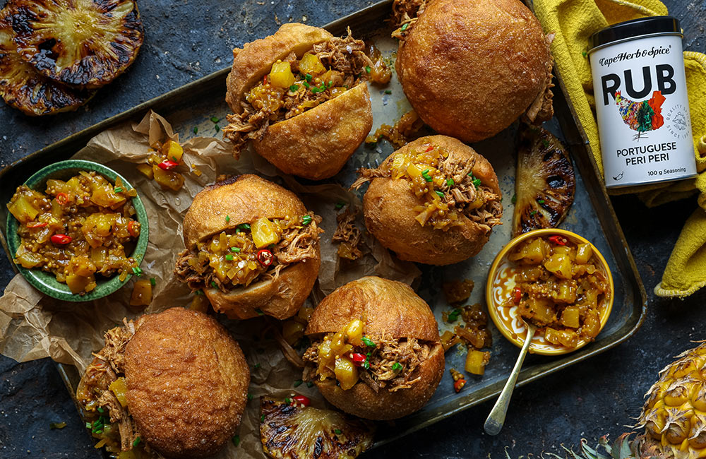 Heritage Day recipes | Peri Peri Pulled Pork Vetkoek with Braaied Pineapple Atchar made using Cape Herb & Spice Portuguese Peri Peri. Image by Crush Online