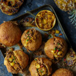 South African Heritage recipes. Peri Peri Pulled Pork Vetkoek with Braaied Pineapple Atchar for Cape Herb & Spice and SA Pork. Image by Crush Online